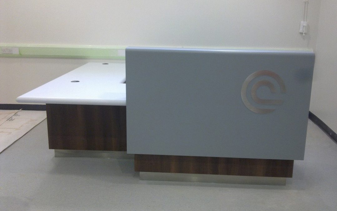 Hospital – Reception desk with laminated timber base and Corian cladding