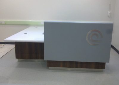 Hospital – Reception desk with laminated timber base and Corian cladding