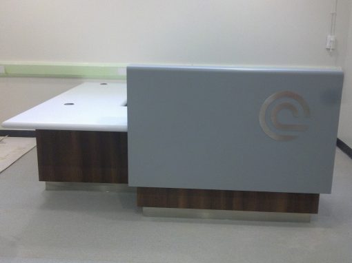 Hospital – Reception desk with laminated timber base and Corian cladding